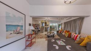 een woonkamer met een bank en een tafel bij Villa Belle Vue- 4BHK Private Pool & Party Hall By StayMonkey in Lonavala