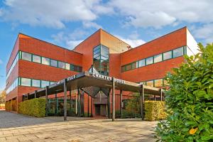 a large brick building with a sign in front of it at PRIME City Centre Location, THE JUKE BOX SUITE, Secure Gated FREE Parking Space, Unique STYLISH Apartment, Two Bathrooms in Milton Keynes