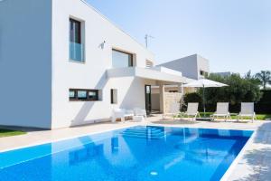 a villa with a swimming pool and a house at Ville Edilia Vacanze in Marina di Ragusa