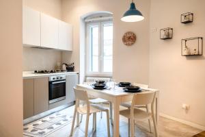 a kitchen with a table and chairs in a room at Martini Matera 2-luxury apartment in Matera
