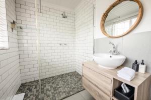 a bathroom with a sink and a mirror at Corner House Residence in Franschhoek +43 photos