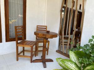 a table and two chairs and a table and a chair at Mango Room Mandalika in Kuta Lombok