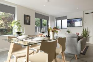 a dining room and living room with a table and chairs at Blackwood in Hornsea