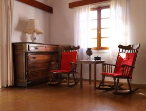 a room with two chairs and a dresser and a table at Belle Epoque - Holiday Home in Aegina Town +20 photos