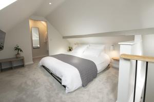 a bedroom with a large white bed with white pillows at Blackwood in Hornsea