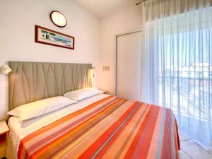 a bedroom with a bed with a large window at Hotel Vienna in Gabicce Mare