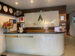 a reception counter in a hotel with clocks on the wall at A25 Hotel - 28 Trần Quý Cáp in Hanoi