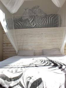 a bed with zebras on the back of it at ParadiseGarden Backpackers in Windhoek