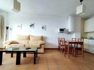a living room with a couch and a table at Apartamentos Arttyfal con parking y WiFi by SURYNIEVE in Sierra Nevada