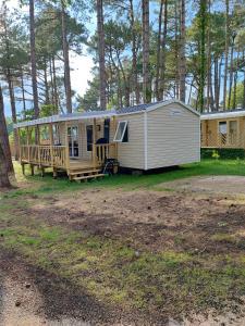 a mobile home with a porch and a deck at MOBIL HOME in Piriac-sur-Mer