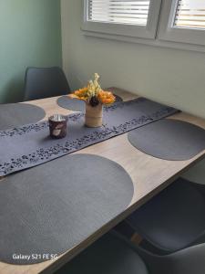 a wooden table with a vase of flowers on it at Apartment Bochum in Bochum