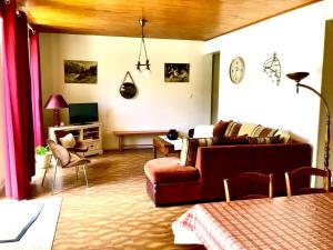 a living room with a couch and a table at La Maison de Marie « Le Rocher » in Saint-Bonnet-en-Champsaur