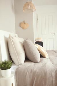 a bed with white pillows on top of it at Im Fachwerk – Wohlfühlen, Entspannen & Wandern im Grünen in Gladenbach