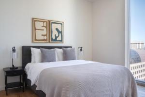 a bedroom with a large white bed with a window at Downtown 2BR w Gym WD BBQ nr Dining Shops SEA-634 in Seattle