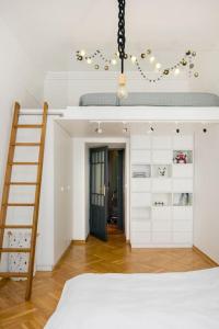 a bedroom with a bunk bed and a ladder at Warsaw Center 110 m2 Spacious and Elegant Apartment in Warsaw