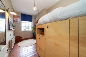 a room with a bed on top of wooden cabinets at Beautiful and Spacious 1BR apt, Bethnal green in London