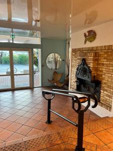 a bench in a living room with a fireplace at Hotel du Porge in Le Porge