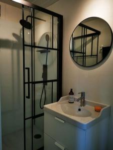 a bathroom with a sink and a mirror at Nydelig lite hus med egen vedfyrt baksteovn. in Kaupanger