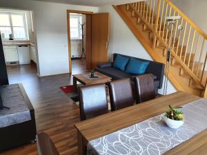 a living room with a couch and a table at Haus Kampl - Appartement Aussee in Bad Mitterndorf