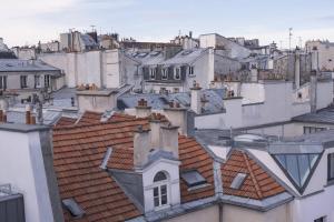 a view of roofs of buildings in a city at Renaissance Paris Republique Hotel & Spa in Paris
