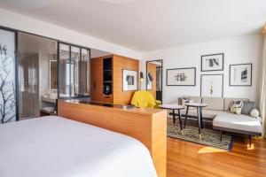 a bedroom with a bed and a living room at Renaissance Paris Republique Hotel & Spa in Paris +288 photos