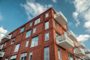 a tall red brick building with balconies on it at Trompstraat Eindhoven in Eindhoven