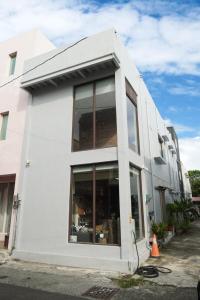 a white building with a large window at 山森三室墾丁包棟民宿3Rooms in Nanwan