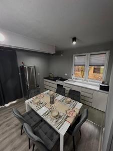 a kitchen with a table and chairs in a room at Dębowy Zakątek in Dębowa Wola +7 photos