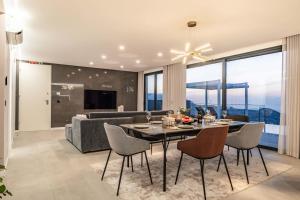 a living room with a table and a couch at Villa Boa Nova Verde by LovelyStay in Funchal