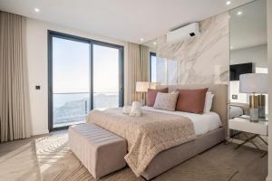 a bedroom with a large bed and large windows at Villa Boa Nova Verde by LovelyStay in Funchal +26 photos