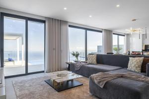 a living room with a couch and a table at Villa Boa Nova Verde by LovelyStay in Funchal