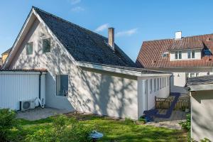 a white building with a garage and a house at Cosy One in Struer