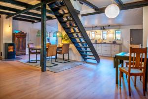 a kitchen and dining room with a spiral staircase in a loft at Cosy One in Struer