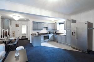 a kitchen with a refrigerator and a table in a room at Modern 4 bedroom Burnham Slough in Burnham