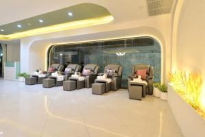 una sala de espera con sillas en el vestíbulo en Tori crown hotel en Bangkok