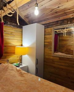 a bedroom with a white cabinet and a mirror at Olympos Ceratonia Dağ evi in Kumluca
