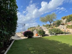 a garden with rocks and green grass and plants at addview 1 in Nafplio