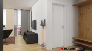 een kamer met een deur, een televisie en een bureau bij KOCAK - Exklusives Apartment im Zentrum in Reutlingen