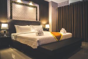 Postel nebo postele na pokoji v ubytování CK Resort Pattaya