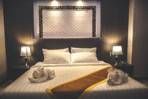 Postel nebo postele na pokoji v ubytování CK Resort Pattaya