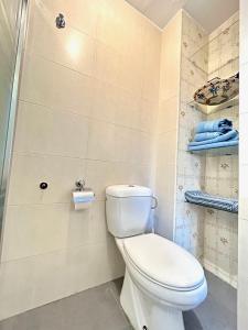 a bathroom with a white toilet in a room at Hispalis Alfonso X in Seville