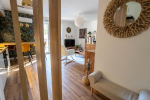 a living room with a mirror on the wall at Happy Island Luxury Apartman Sárvár in Sárvár