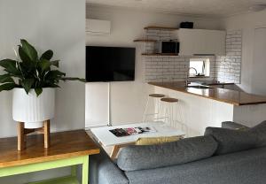 a living room with a couch and a kitchen at Montego Sands Resort in Gold Coast