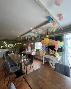 a dining room with a table and balloons on the ceiling at The 1645 Inn in Nairn