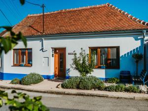 a blue and white house with a red roof at Levandulová chalupa in Vrbice