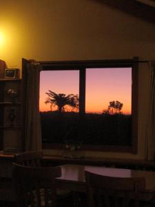 a room with a window with a view of a sunset at Beaconstone Eco Stay - off grid retreat in Charleston