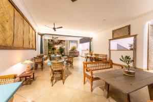 a living room with tables and chairs and a table at The Fort House in Galle