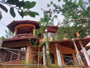 a large house with a balcony on top of it at Mystique Hideout in Kandy