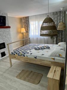 a bedroom with a large bed with a wooden frame at Ca acasă Corbu in Corbu