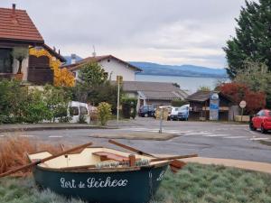 a boat sitting on the grass in a street at Le Chalet Du Redon in Margencel